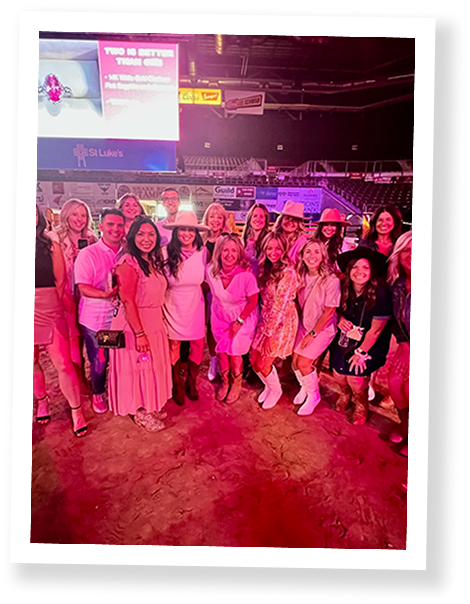 Large group posing in rodeo arena