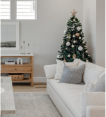 Bed with black metal frame and white bedding in a light room with light beige rug