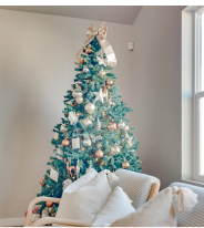 Vase with yellow flowers sitting on a wooden dining table