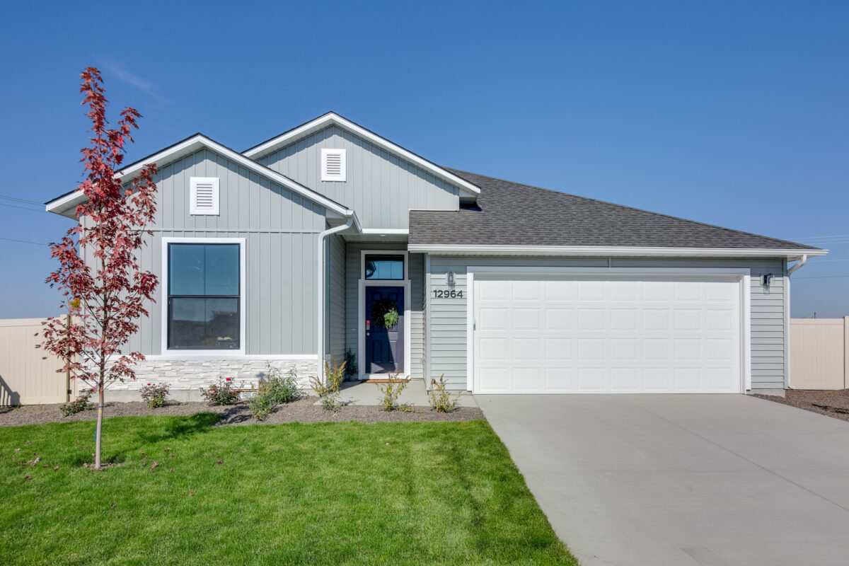 Stunning new home with modern design, featuring a spacious two-car garage, stylish exterior finishes, and beautiful landscaping—an example of the quality and craftsmanship coming soon to Wild Blue.